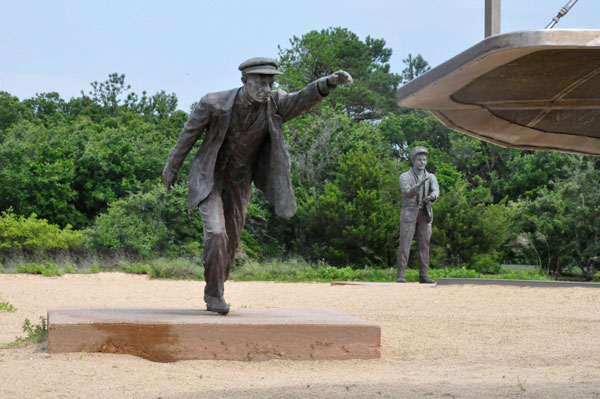 Wilbur Wright as he stradled the wing